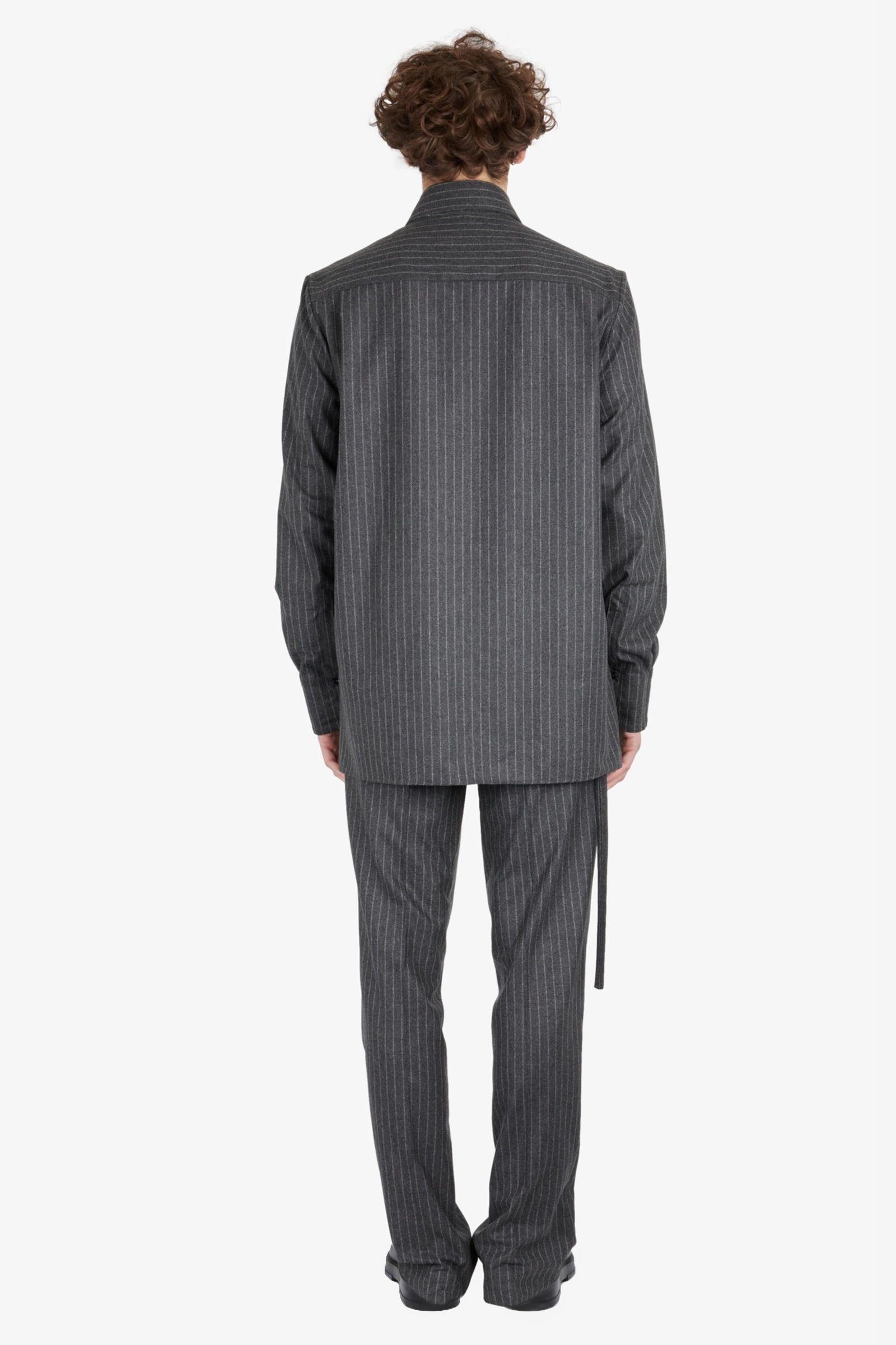 Tailored trousers with strapped falling pocket